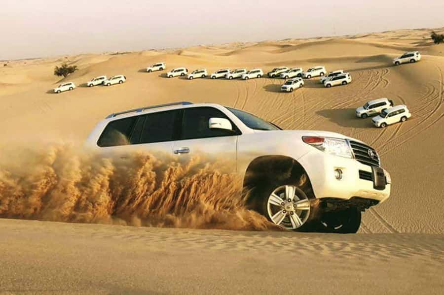 Desert Safari, Quad Bike, Camel Ride, Falcon & Sandboarding - Doha pickup and the 4x4 ride into the real desert