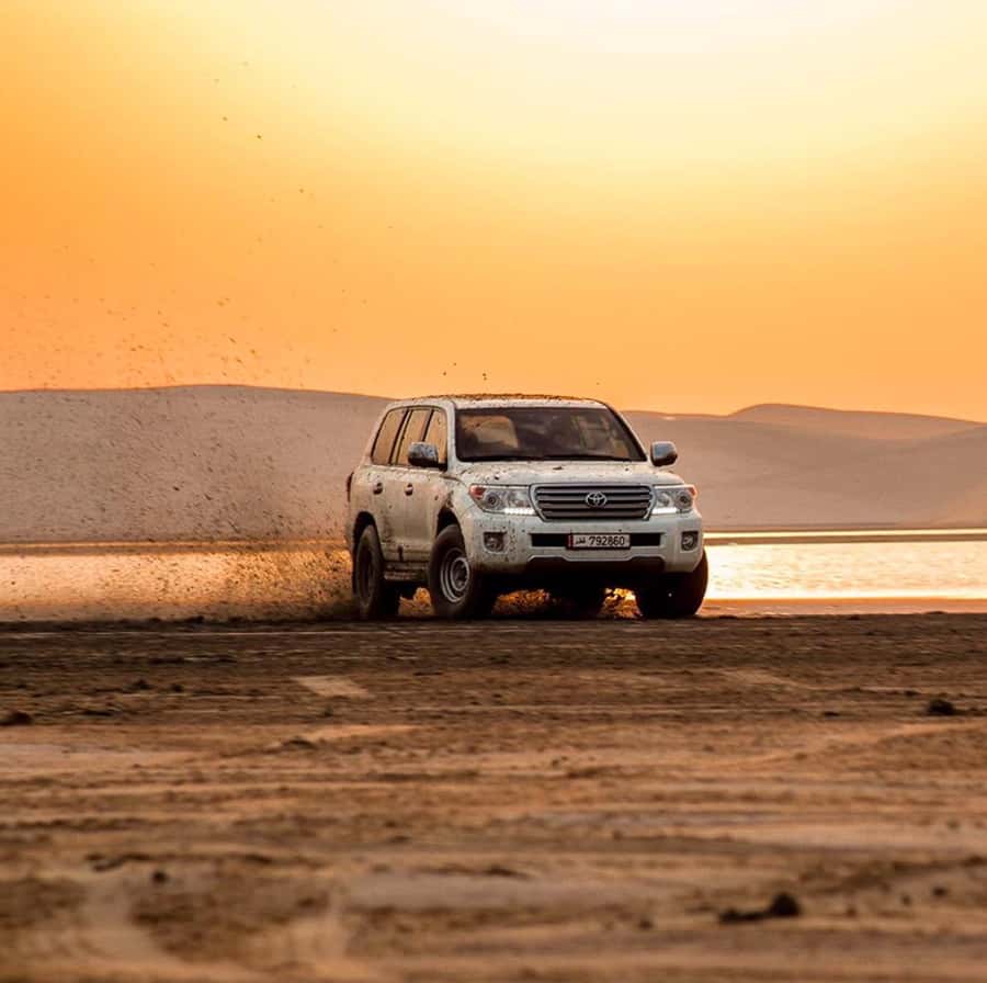 Doha: Inland Sea, Desert Safari, Camel Ride and Sandboarding - Sandboarding on Qatar’s dunes, with real instruction time