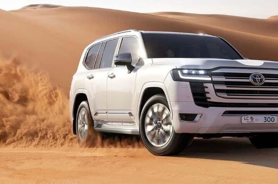 Doha: Safari, Camel Ride, Sand boarding and Inland Sea Tour - Sandboarding down Qatar’s dunes, with guide help