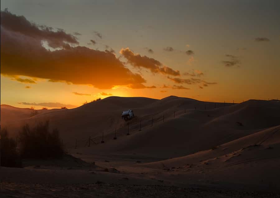 Doha: Sunset Safari, Dune Bashing, Sandboarding & Camel Ride - Sandboarding at the dunes, plus that short sunset window