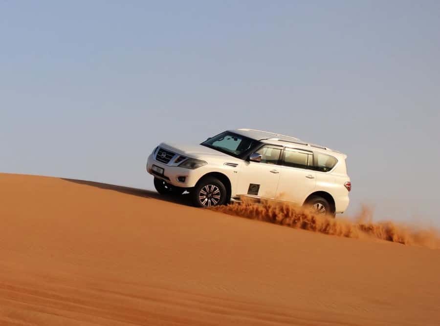 Qatar: Sunset Desert Safari with Camel Ride & Sandboarding - Dune bashing near sunset at the Inland Sea